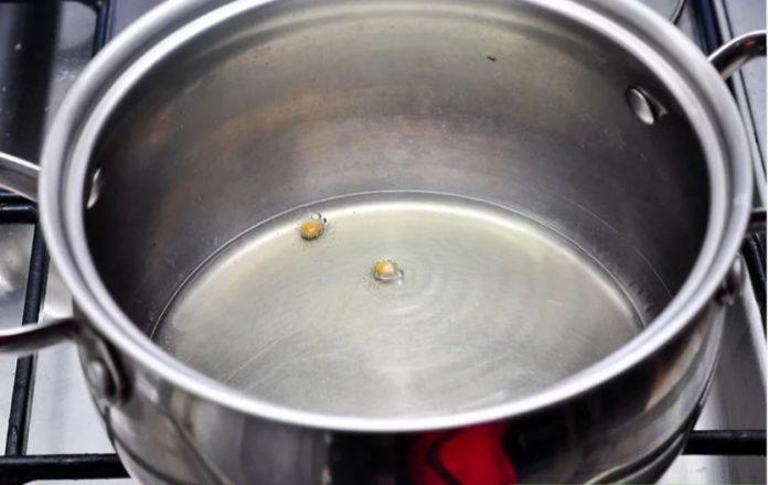 Cho 2-3 hạt ngô vào nồi để chắc chắn dầu đã đủ nóng (Ảnh: Internet)