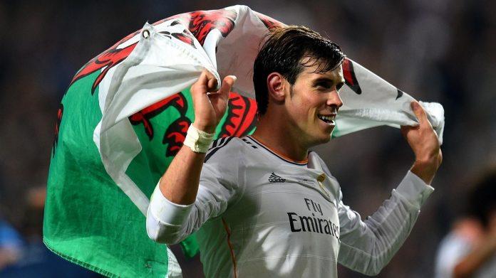 Bale ăn mừng chức vô địch Champions League với lá cờ xứ Wales (Nguồn: Internet)