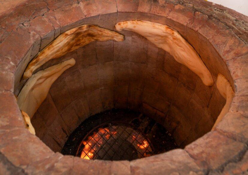 Close-up of Georgian Shoti bread baked in a traditional brick oven torn, tandoor