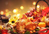 Roasted whole turkey on festive rustic table with autumn decoration for Thanksgiving Day